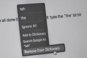 A close-up photo of a computer screen showing a user removing the misspelled word “teh” from the dictionary in a word processor.