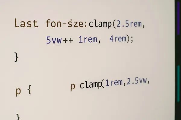 Close-up of a computer screen showing CSS code with clamp values used for responsive typography.